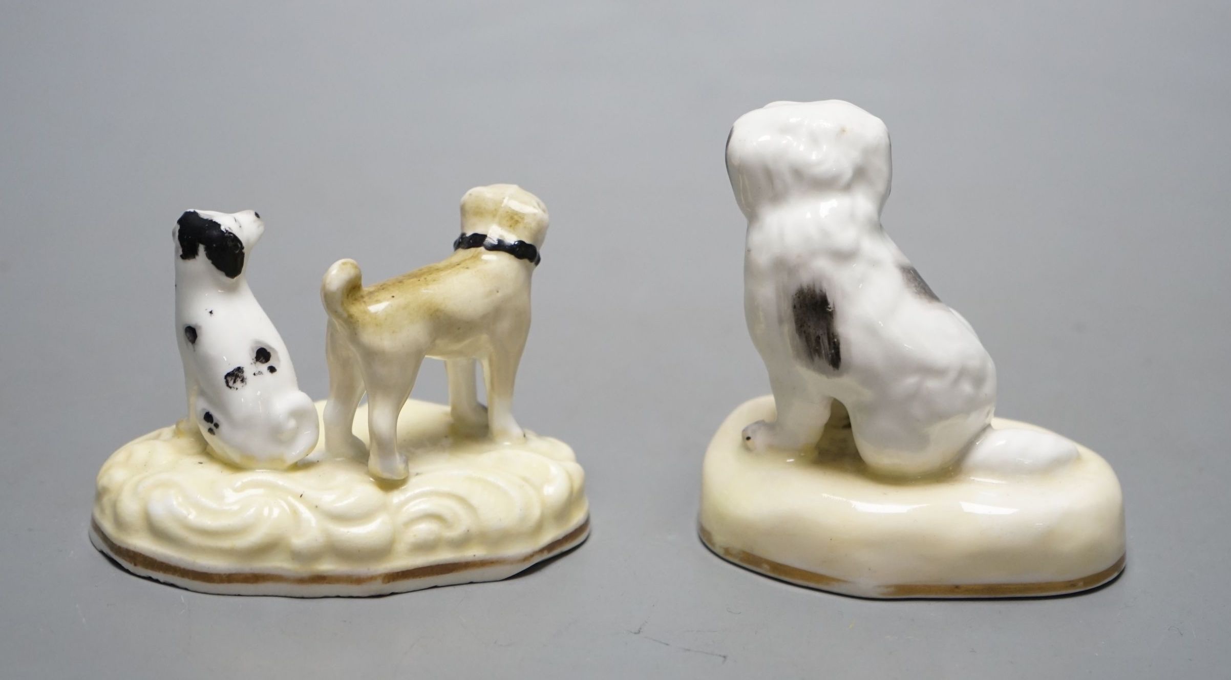 A Samuel Alcock porcelain a group of a pug dog and a spaniel, c.1835-50, together with a similar figure of a seated spaniel, impressed marks 342 and 183. Cf. Dennis G.Rice Dogs in English porcelain, colour plate 36 and f